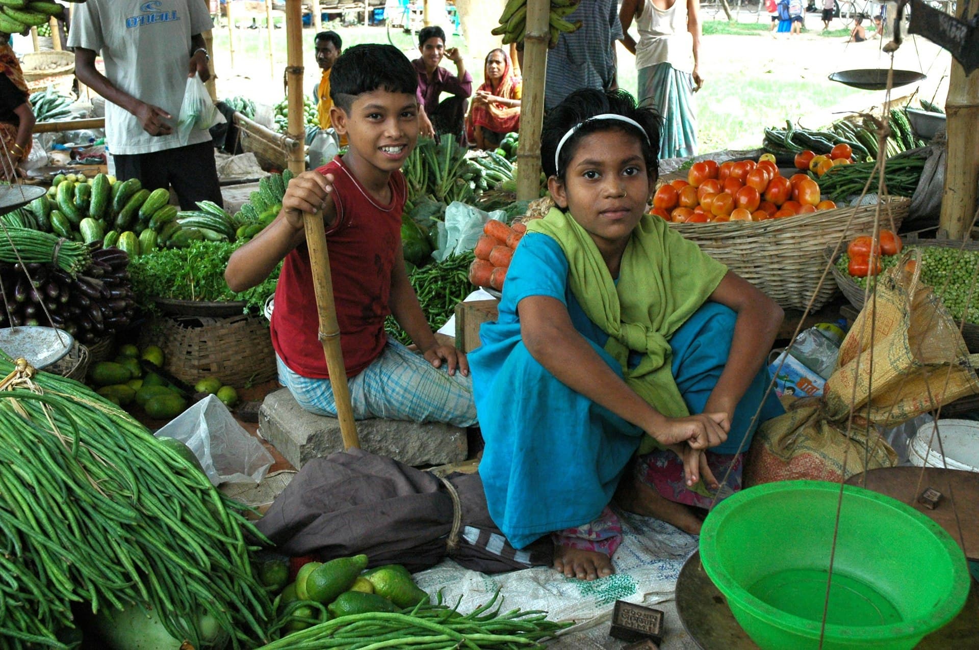 A child picking out fresh produce at a grocery store